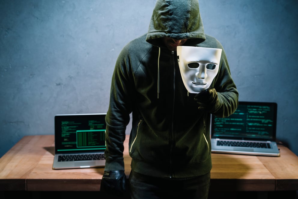 https://sibermate.com/hubfs/hacker-holding-mask.jpg