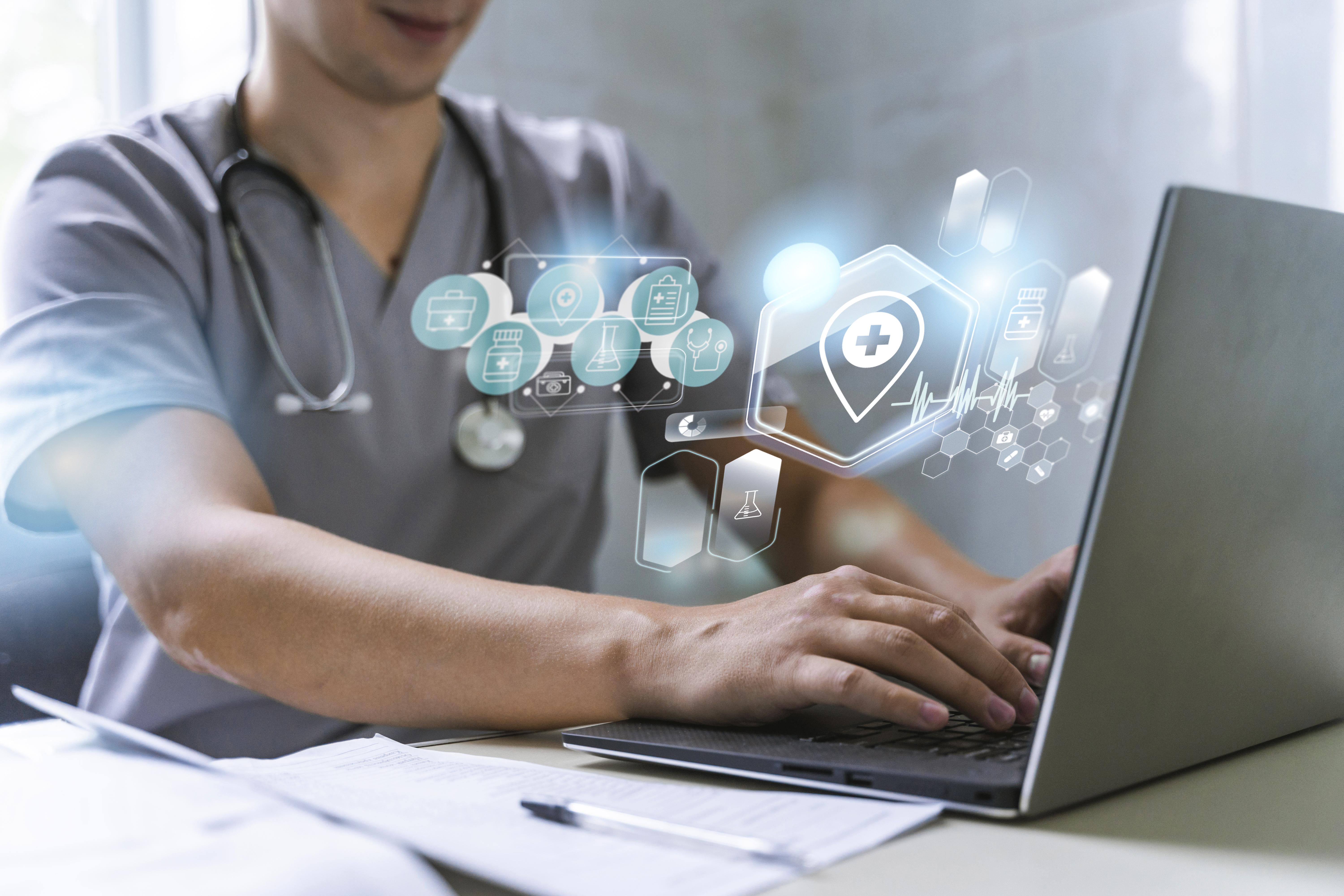 Dokter menggunakan laptop dengan antarmuka digital untuk pengelolaan data medis
